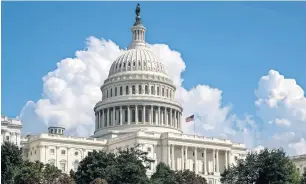  ?? Washington Post AP ?? An American flag flies on the US Capitol in Washington. The book by journalist Bob Woodward is the latest to throw the Trump administra­tion into damage-control mode. —