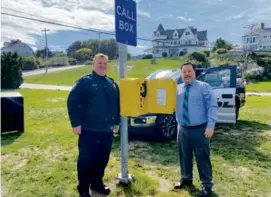  ?? TOWN OF COHASSET ?? Cohasset officials William Quigley and Chris Senior with a call box in a “cellular dead zone.” Now a cell tower is coming.