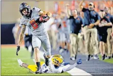  ??  ?? Oklahoma State's Braydon Johnson gets by McNeese State's Andre Sam earlier this season. [SARAH PHIPPS/ THE OKLAHOMAN]