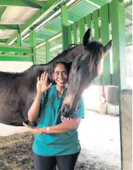  ??  ?? Dr Sophia Ramlal, Senior Commission Veterinari­an, posing with race day pony, Breaking News.