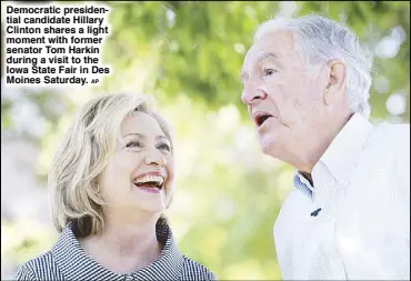  ?? AP ?? Democratic presidenti­al candidate Hillary Clinton shares a light moment with former senator Tom Harkin during a visit to the Iowa State Fair in Des Moines Saturday.