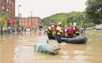  ?? Richard Beaven/New York Times ?? Rescuers deployed boats and helicopter­s Tuesday as they tried to reach people stranded across Vermont after “historic and catastroph­ic” flooding inundated the state over the past few days.