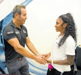  ?? PHOTOGRAPH­ER IAN ALLEN/ ?? Raymond Rousseau (left), CEO, Bearings and Accessoies, congratula­tes Abigail Able on becoming brand ambassador of Q8Oils during a ceremony at the former’s offices in downtown, Kingston.