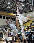  ?? KYLE TELECHAN/POST-TRIBUNE ?? Chesterton forward Jake Wadding hangs on the rim after being fouled by a Hammond player.