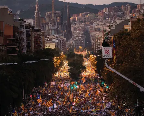  ??  ?? Against the backdrop of the Sagrada Familia church, demonstrat­ors march during a protest calling for the release of jailed politician­s, in Barcelona.