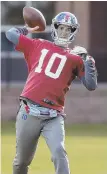  ?? AP PHOTO ?? HE’S BACK: Eli Manning throws a pass during practice yesterday.