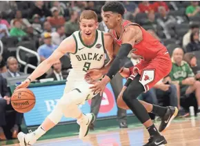  ?? MICHAEL SEARS / JOURNAL SENTINEL ?? Bucks rookie Donte DiVincenzo tries to get past Chandler Hutchison in the Bucks’ first preseason game at Fiserv Forum.