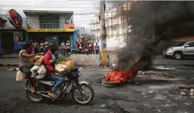  ?? Rebecca Blackwell / Associated Press ?? A barricade burns during a protest Monday in Port-au-Prince, Haiti, calling for President Jovenel Moise to give up power. Moise, who began his five-year term in 2017, has said he will not leave and instead has called for unity and dialogue.