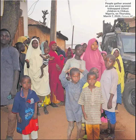  ?? Picture: AP ?? People gather around an area were gunmen kidnapped school children in Chikun, Nigeria, on Thursday, March 7, 2024.