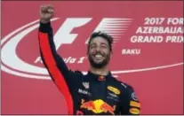  ??  ?? THE ASSOCIATED PRESS Red Bull driver Daniel Ricciardo of Australia celebrates on the podium after winning the Formula One Azerbaijan Grand Prix on Sunday.