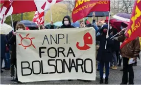  ?? Photograph: Luca Bruno/AP ?? Members of the anti-fascist group ANPI in Anguillara Veneta on Monday with a banner reading ‘Bolsonaro out’.