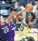  ?? MICHAEL CONROY/AP ?? Purdue guard Jaden Ivey (23) shoots over Northweste­rn forward Pete Nance (22) during the second half on Saturday.