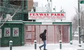  ??  ?? Fenway Park in Boston covered in snow. The Boston area had only about 4in of snow, but the weather made for a messy commute Photograph: Scott Eisen/Getty Images