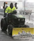  ??  ?? A man removes snow with a plough at Dublin Airport. Photo: Damien Eagers