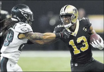  ?? Bill Feig The Associated Press ?? Saints wide receiver Michael Thomas (13) grabs a 42-yard reception against Eagles free safety Avonte Maddox in New Orleans’ 20-14 victory on Jan. 13.