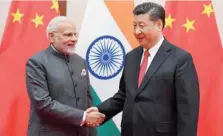  ?? — Reuters ?? Prime Minister Narendra Modi with Chinese President Xi Jinping during the 18th SCO Summit in Qingdao on Saturday.