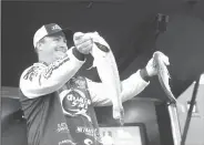 ?? NWA Democrat-Gazette/FLIP PUTTHOFF ?? Scott Canterbury of Springvill­e, Ala., who won the 2016 FLW tournament at Beaver Lake, shows two bass Saturday from his five-fish limit that weighed 11 pounds, 10 ounces.