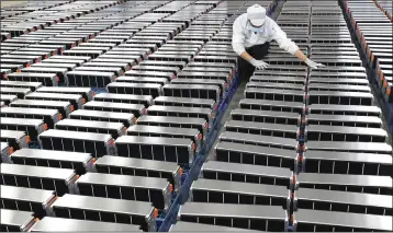  ?? FEATURECHI­NA VIA AP IMAGES ?? A worker checks parts for the battery packs at a factory of Sunwoda Electric Vehicle Battery in Nanjing, China, which makes lithium batteries for electric cars.