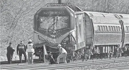  ??  ?? Amtrak investigat­ors inspect a fatal train crash April 3, 2016, in Chester, Pa. The Amtrak train struck a piece of constructi­on equipment just south of Philadelph­ia, causing a derailment. MICHAEL BRYANT/AP