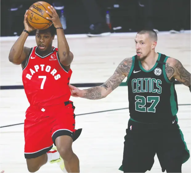  ?? Kim Klement / USA TODAY Sports ?? Toronto Raptors guard Kyle Lowry passes the ball with Boston Celtics centre Daniel Theis by his side in Monday night’s playoff game.