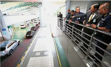  ??  ?? Area check: Hasni (left) and Tee (second from right) conducting an official visit to the Bangunan Sultan Iskandar Customs, Immigratio­n and Quarantine (CIQ) complex in Johor Baru.