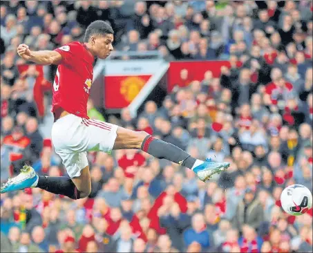  ?? REUTERS ?? Marcus Rashford scores for Manchester United in the first half of their Premier League clash against Liverpool at Old Trafford on Sunday.