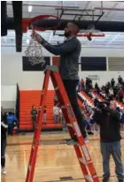  ?? Photo David Birdsell ?? Coach K.C. Ahrens cuts down the final strings of the net