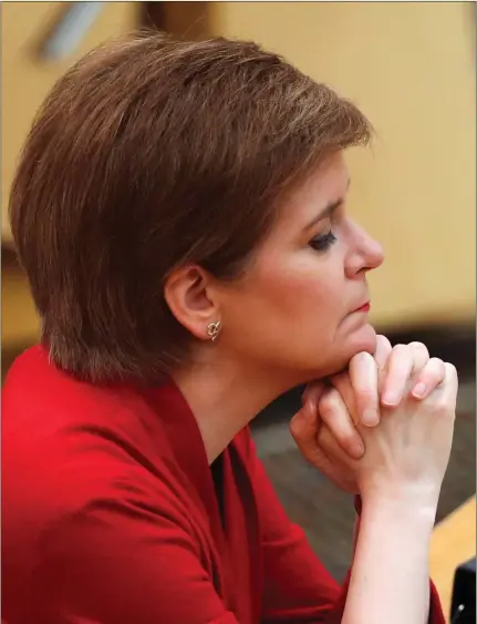  ?? Picture: Russell Cheyne/getty ?? A pensive Nicola Sturgeon at the Scottish Parliament to make a statement on lifting coronaviru­s restrictio­ns