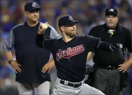 ?? ORLIN WAGNER — THE ASSOCIATED PRESS ?? Indians starter Corey Kluber takes a practice pitch in front of Manager Terry Francona, left, and umpire Ron Kulpa during the sixth inning.