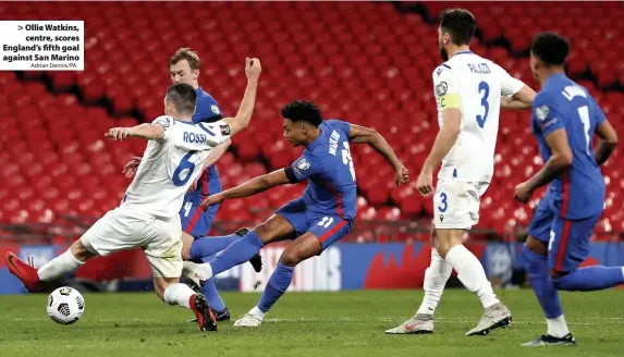  ?? Adrian Dennis/PA ?? > Ollie Watkins, centre, scores England’s fifth goal against San Marino