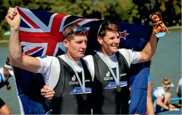  ?? AP ?? New Zealand’s Chris Harris and John Storey celebrate their bronze medal in the men’s double sculls.