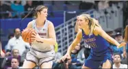  ?? Icon Sportswire via Getty Images ?? UConn forward Kyla Irwin (25) looks to pass with DePaul Blue Demons guard Kelly Campbell (20) defending during the second half on Nov. 28 at the XL Center in Hartford.