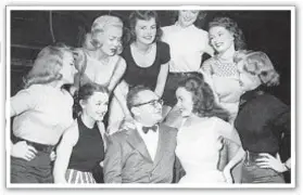  ?? ?? Monte Proser, producer of the Broadway show, “Billion Dollar Baby” and other Broadway night club attraction­s, with a group of girls surroundin­g him