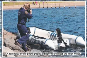  ??  ?? A forensics officer photograph­s a dinghy found near the Four Winds.