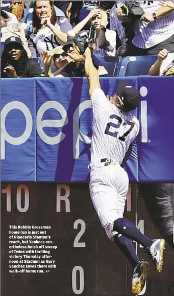  ?? AP ?? This Robbie Grossman home run is just out of Giancarlo Stanton’s reach, but Yankees neverthele­ss finish off sweep of Twins with thrilling victory Thursday afternoon at Stadium as Gary Sanchez saves them with walk-off home run.