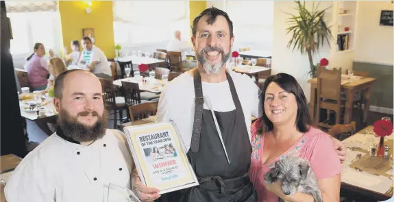  ??  ?? John and Della McGinn with chef Bruce Ingle receiving the Restaurant of the Year award at the Dog In A Doublet
