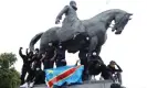  ?? Photograph: Yves Herman/Reuters ?? Black Lives Matter protesters with a DR Congo flag on a statue of Leopold II in Brussels.