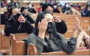  ??  ?? Parishione­rs pray during Mass at Our Lady of Sorrows in the Queens borough of New York on March 7.