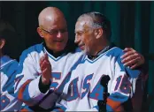  ?? MIKE GROLL — THE ASSOCIATED PRESS, FILE ?? Jack O’Callahan, left, and Mark Pavelich of the 1980 U.S. ice hockey team talk during a “Relive the Miracle” reunion at Herb Brooks Arena in Lake Placid, N.Y., in February 2015.