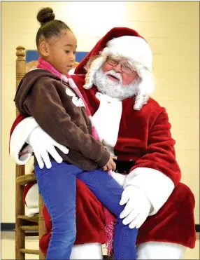  ?? Photo by Mike Eckels ?? Avianna James tells Santa Claus what she wants for Christmas during the Decatur Chamber of Commerce’s Christmas Festival in the cafeteria of Decatur High School Dec. 9.