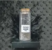  ?? ?? A VIAL labeled “Putin’s Ashes, 100 g” is part of a larger piece at Jeffrey Deitch Gallery.