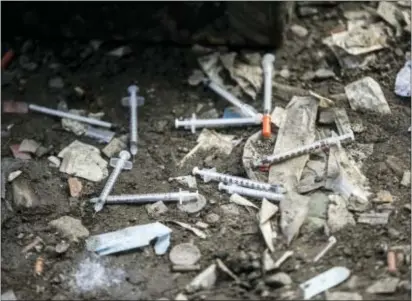  ?? ASSOCIATED PRESS ?? In this February photo, used needles litter the ground at an open-air drug market the Kensington section of Philadelph­ia. along Conrail train tracks in