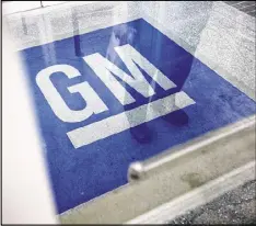  ?? AP 2013 ?? The logo for General Motors decorates the entrance at the site of a GM informatio­n technology center in Roswell. In 2014, GM recalled 2.6 million older small cars worldwide to replace faulty ignition switches.