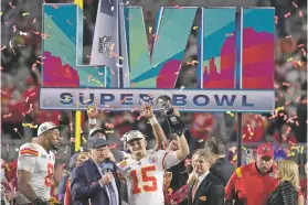  ?? SETH WENIG/THE ASSOCIATED PRESS ?? Chiefs quarterbac­k Patrick Mahomes, center, holds the Vince Lombardi Trophy while talking to Terry Bradshaw after Kansas City beat the Eagles on Sunday in Super Bowl 57 in Glendale, Ariz. The Chiefs won 38-35.