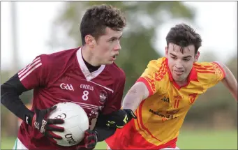  ??  ?? Dylan Furlong (Sarsfields) tries to halt the progress of Oisín Condren (Castle-Craan Gaels).