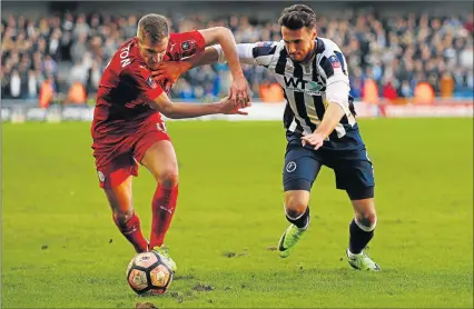  ?? Picture: GETTY IMAGES ?? TOUGH BATTLE: Leicester City’s Marc Albrighton, left, and Lee Gregory of Millwall, right, battle for possession during The Emirates FA Cup fifth round match at The Den on Saturday in London, England. Millwall won 1-0