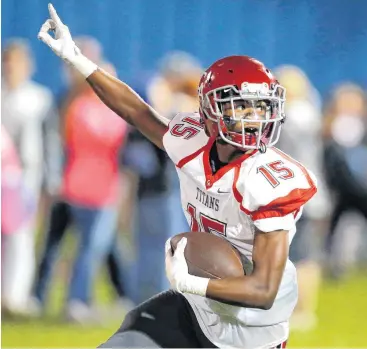  ?? [PHOTO BY BRYAN TERRY, THE OKLAHOMAN] ?? Carl Albert’s Anthony Davis celebrates after catching a touchdown pass during Friday’s game with Guthrie in Guthrie. Carl Albert won, 21-0.