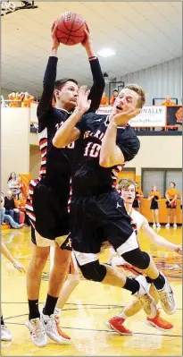  ?? Photograph courtesy of Russ Wilson ?? Senior Blackhawks Matt Thomas and Cole Wright both went for a rebound Friday in the hotly contested game Friday in Gravette with the previously undefeated Lions. Wright backed off after Thomas grabbed the ball. The win Friday maintained the Blackhawks’...
