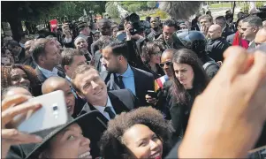  ?? AP PHOTO ?? French President-elect Emmanuel Macron poses with supporters after a ceremony commemorat­ing the abolition of slavery, in Paris, Wednesday.