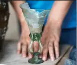  ?? ?? An archaeolog­ist shows a Medieval glass, 14th century A.D. dated to the